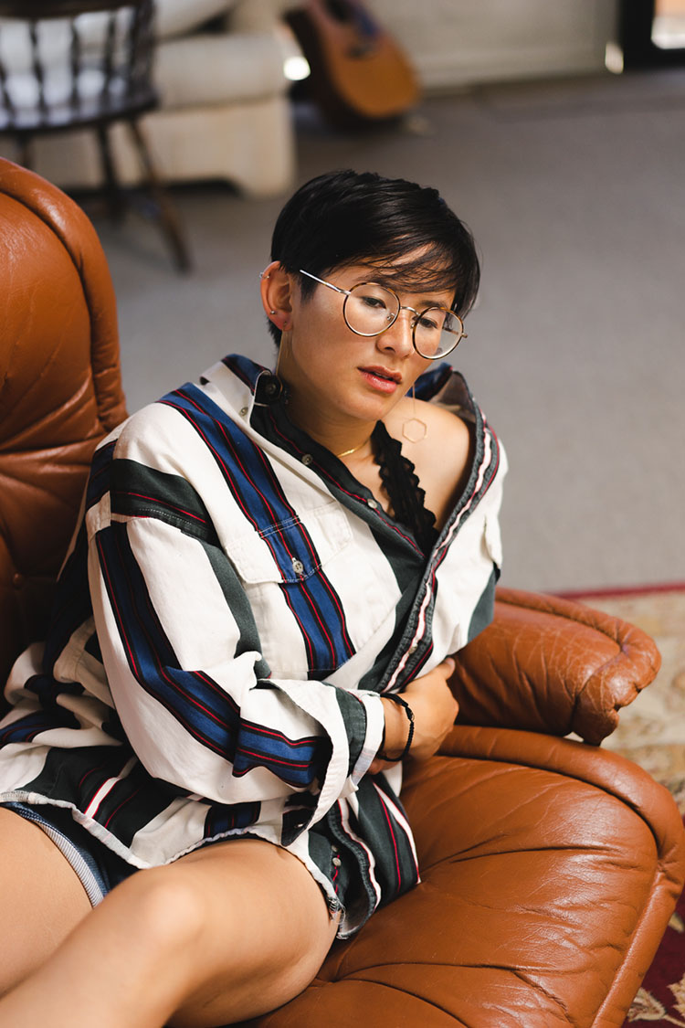 Person laying on recliner staring into distance.